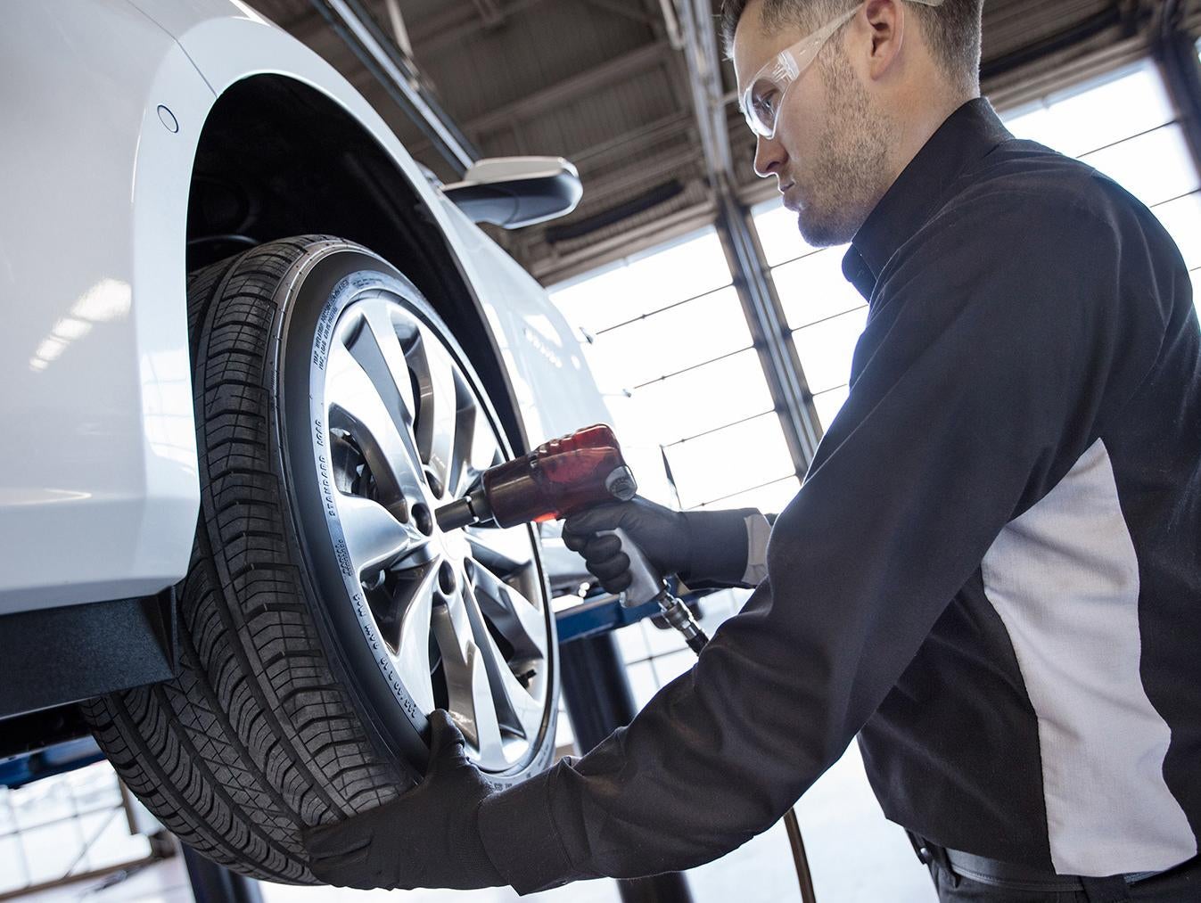 Service Technician working to replace the tire